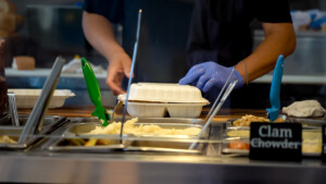 Food being packed up into to go container