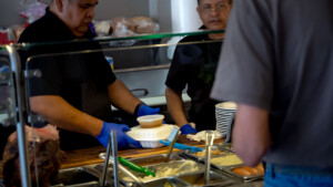 Meals being prepared by two workers