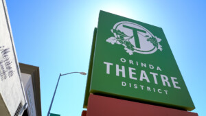 green sign saying Orinda Theatre District