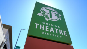 green sign saying Orinda Theatre District