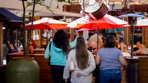 Three woman waiting to be seated at outdoor restaurant