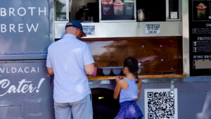 Father and daughter buying ice cream