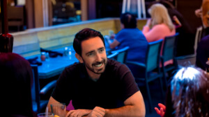 Man in black shirt sitting at a resturant